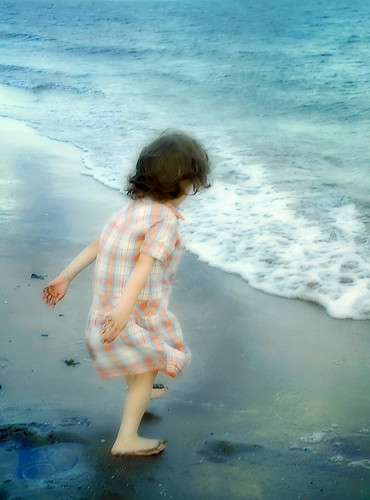 painting of little girl playing by the ocean