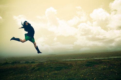 person leaping in an empty field